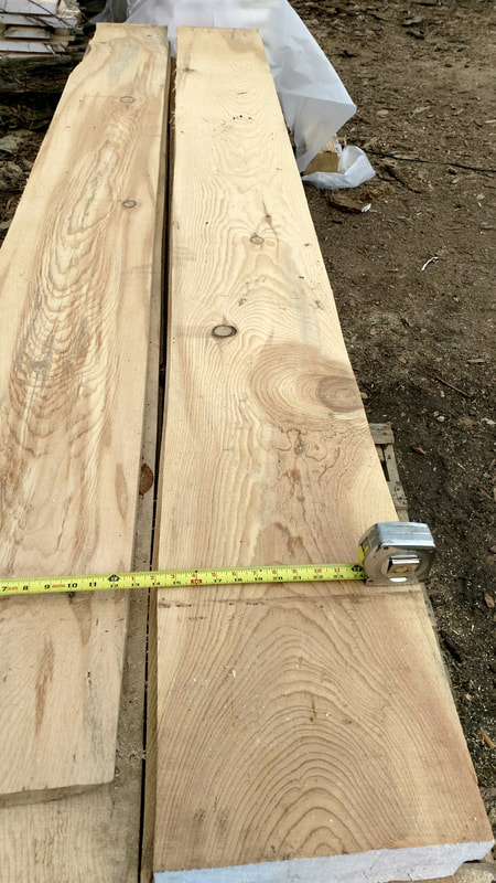 Wood planks created from felled trees during fire mitigation.